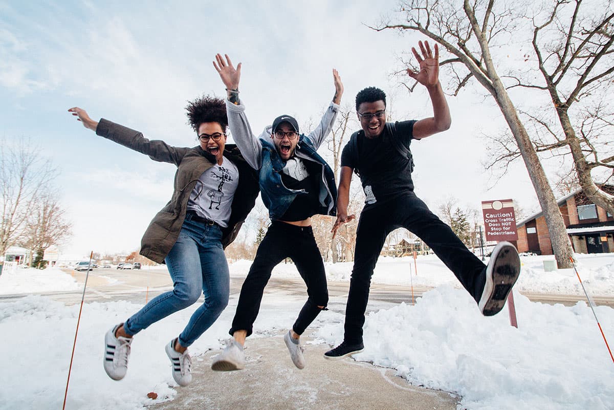 Three Younger People Jump for Joy