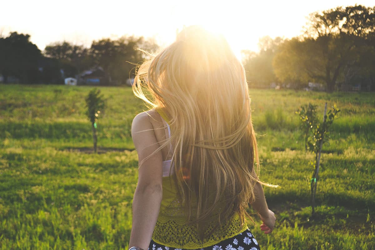 A girl runs into the sunlight