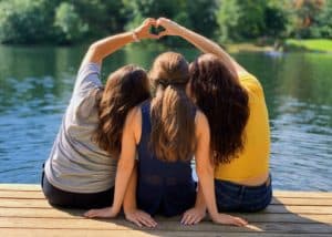 women sitting on dock