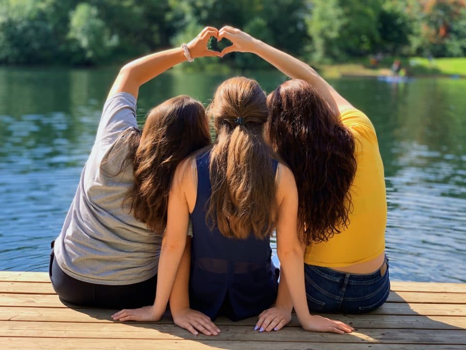 women sitting on dock