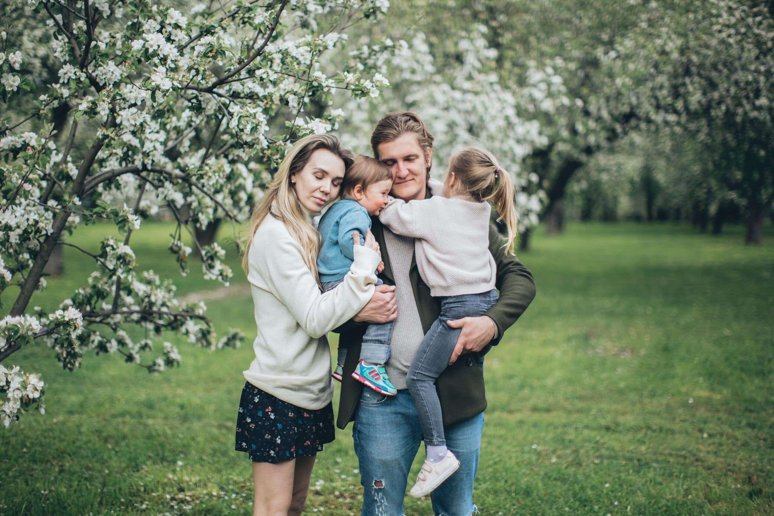 an embraced family of four by a tree dealing with the challenges of dysfunctional families