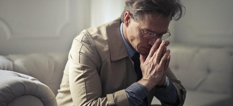 A man considering the benefits of family therapy for addiction recovery.
