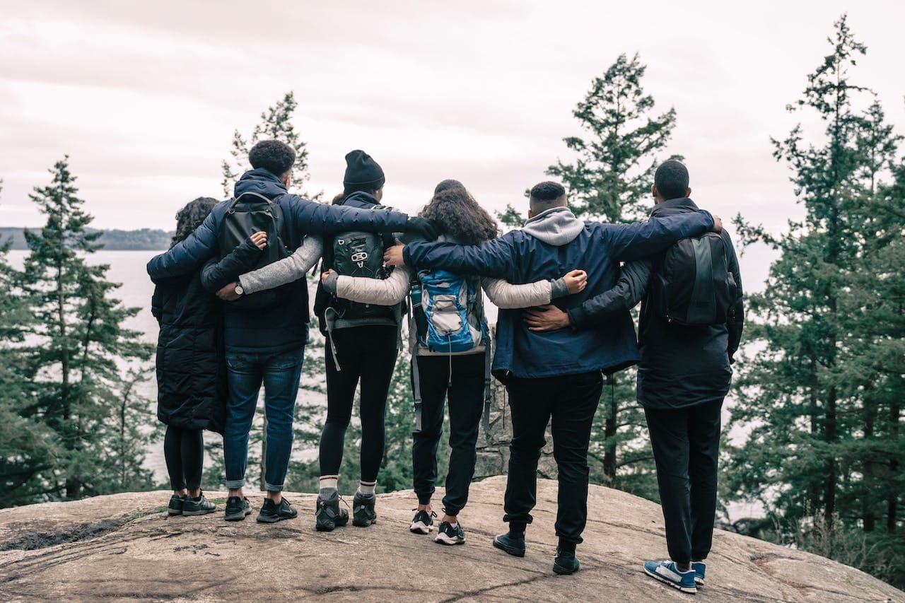 Families dealing with addiction embraced on a hill