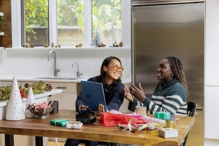Friends talking at a kitchen table.