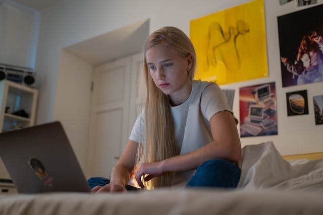 Teenager using a laptop