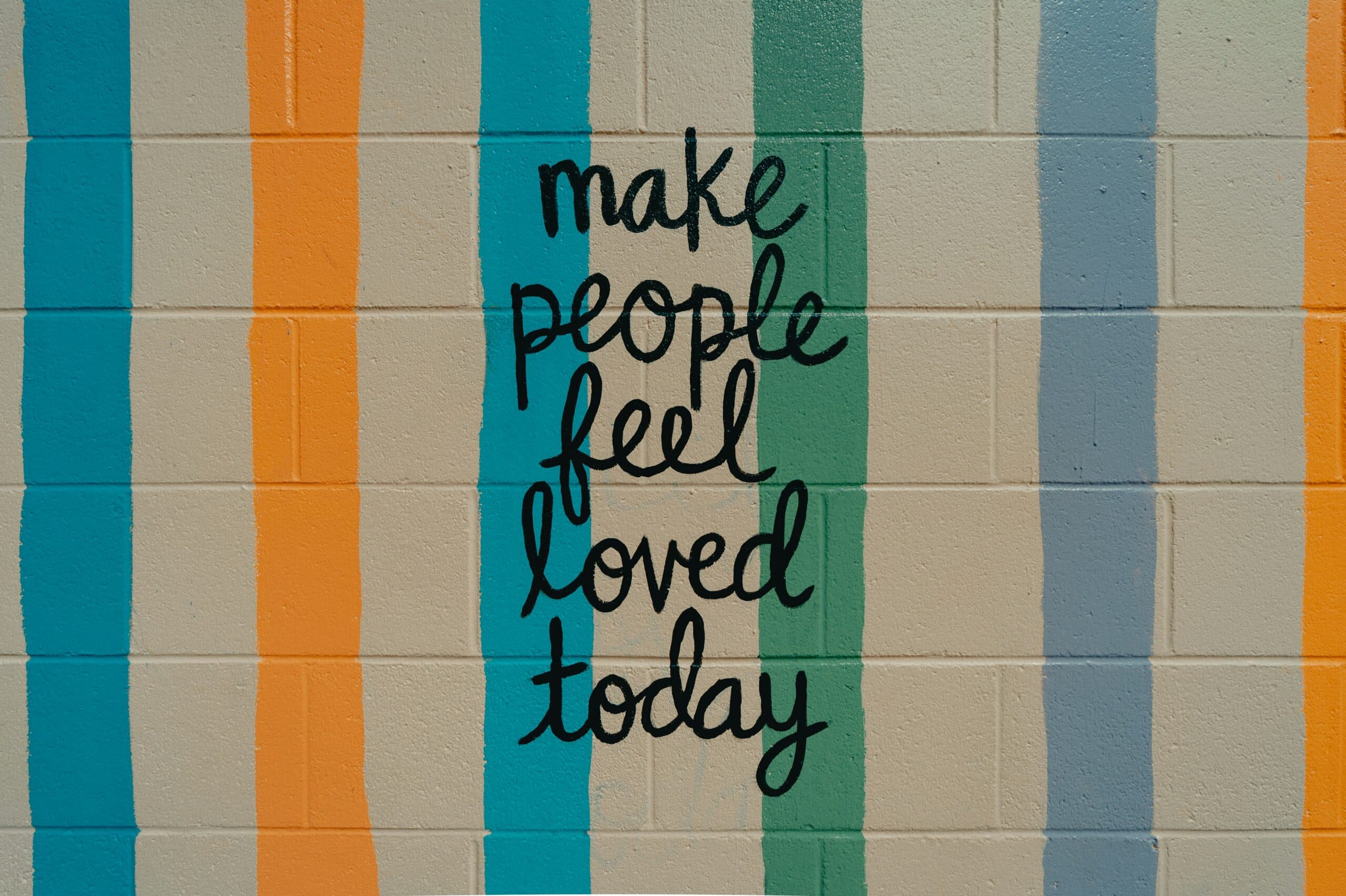 Words on the wall: make people feel loved today, emphasizing the role of attachment in mental wellness