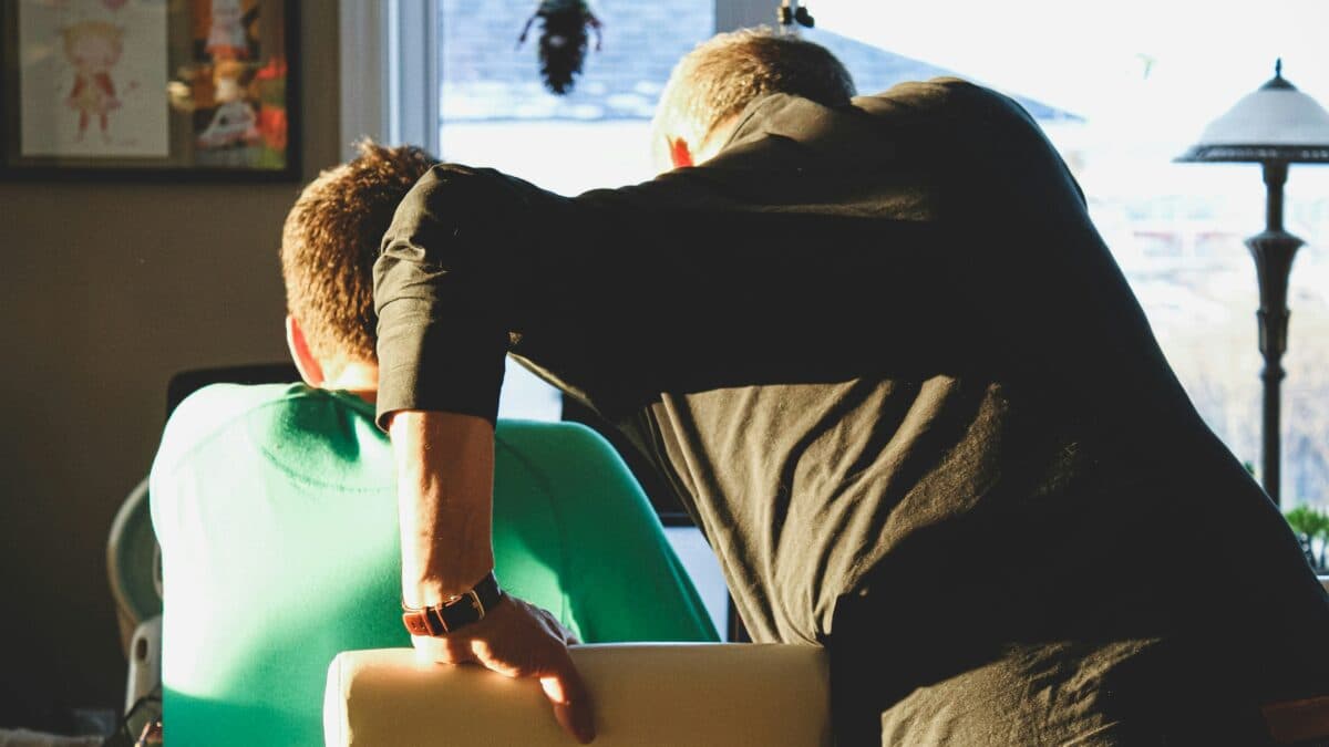 two men looking at laptop together