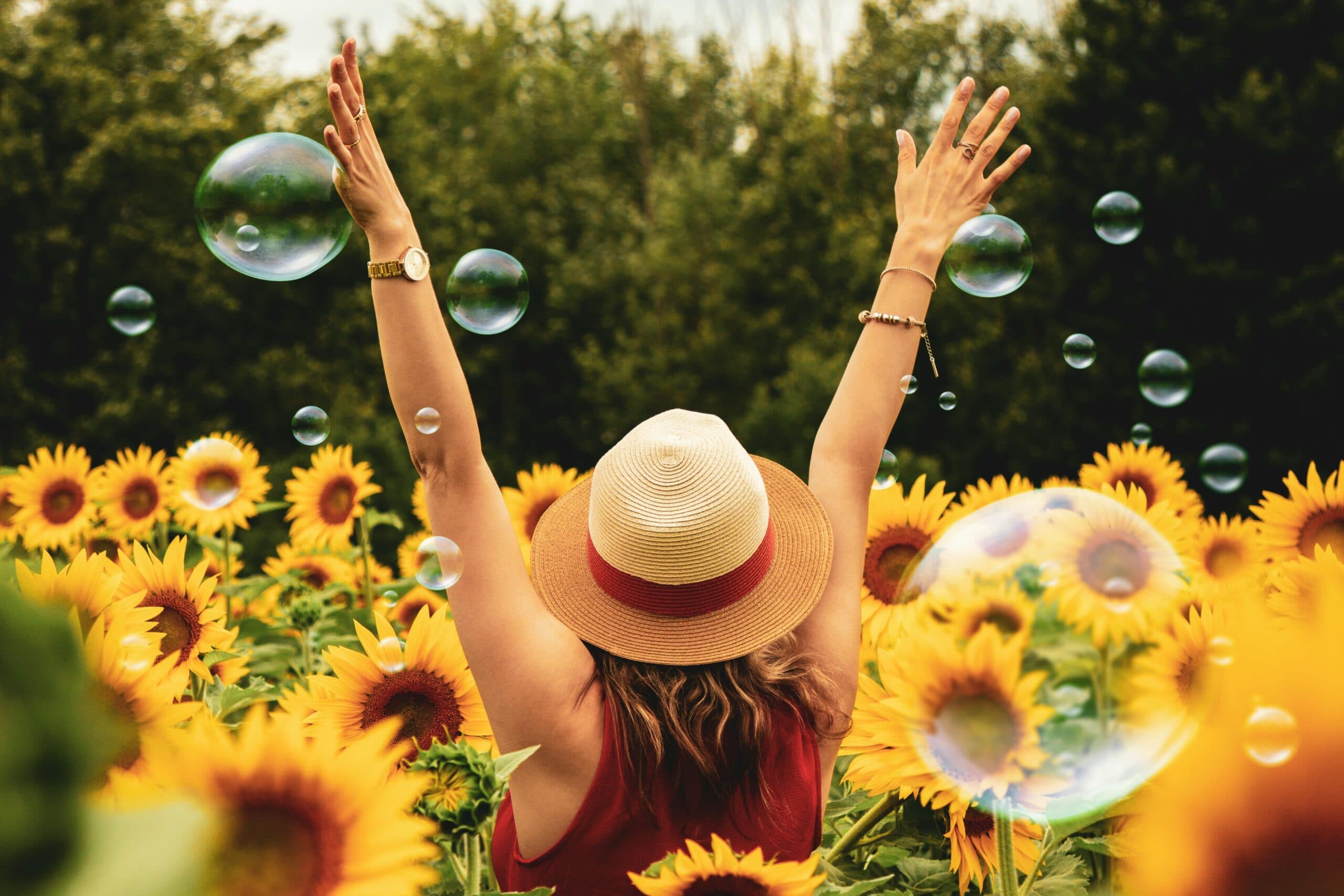 a happy woman in a sunflower field