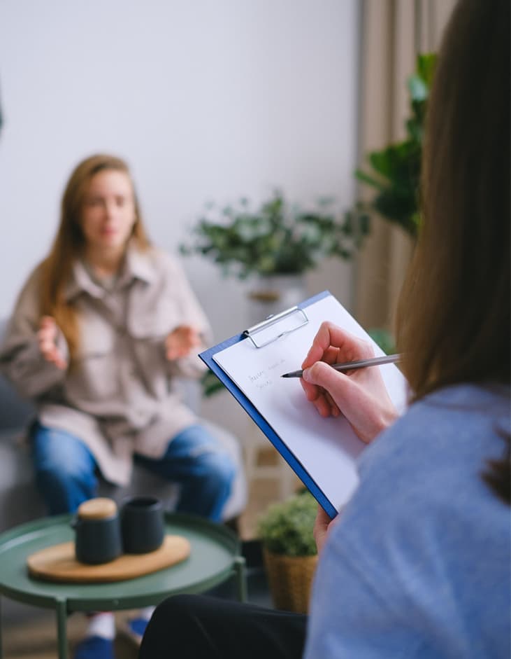 a counselor taking notes